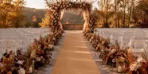 Gold and blush carpet runner colors laid out for an autumn wedding aisle